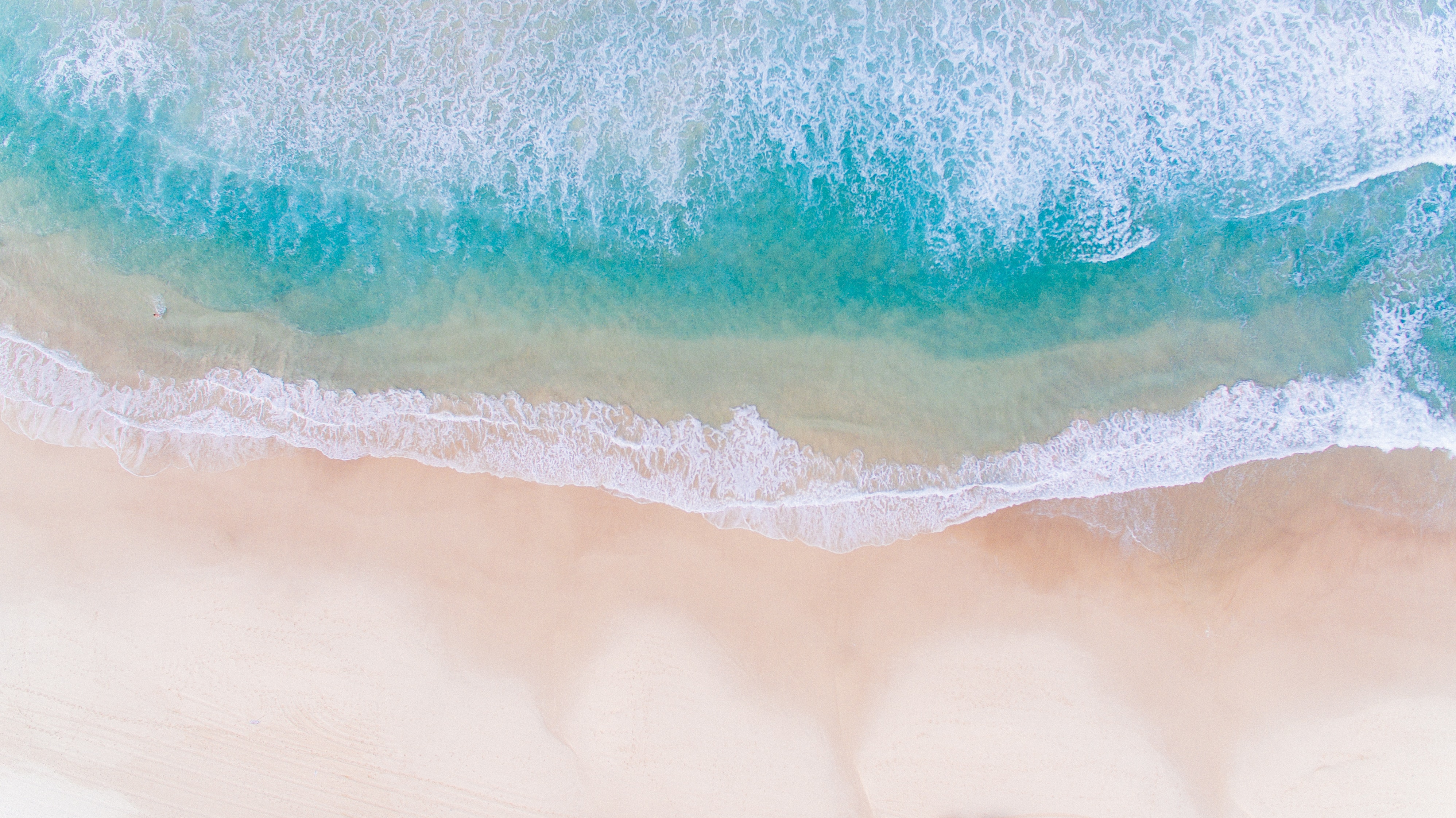 a beach with waves crashing on the shore