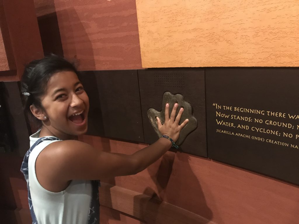 a girl touching a plaque