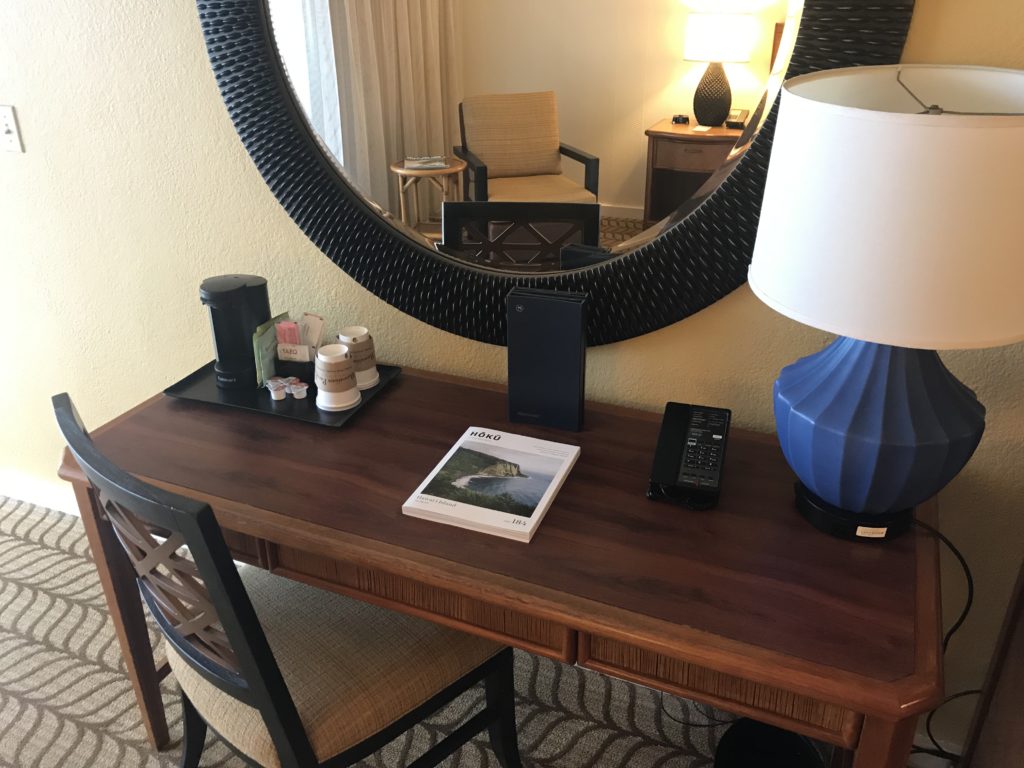 a desk with a mirror and a lamp