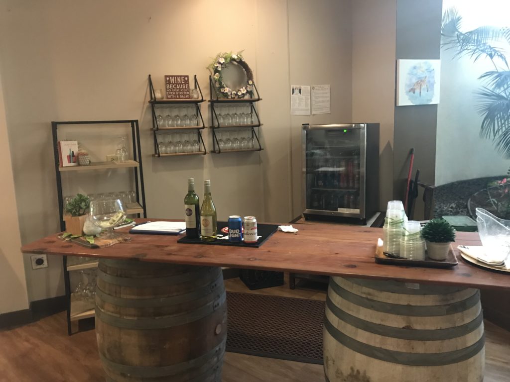 a table with wine barrels and bottles on it