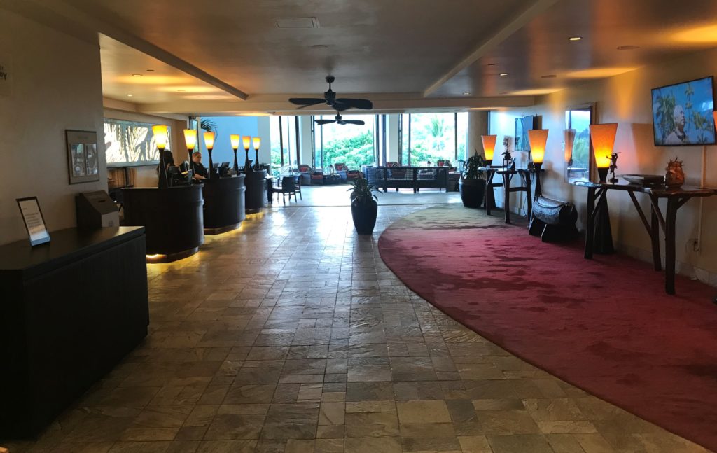 a lobby with a red carpet and a large window