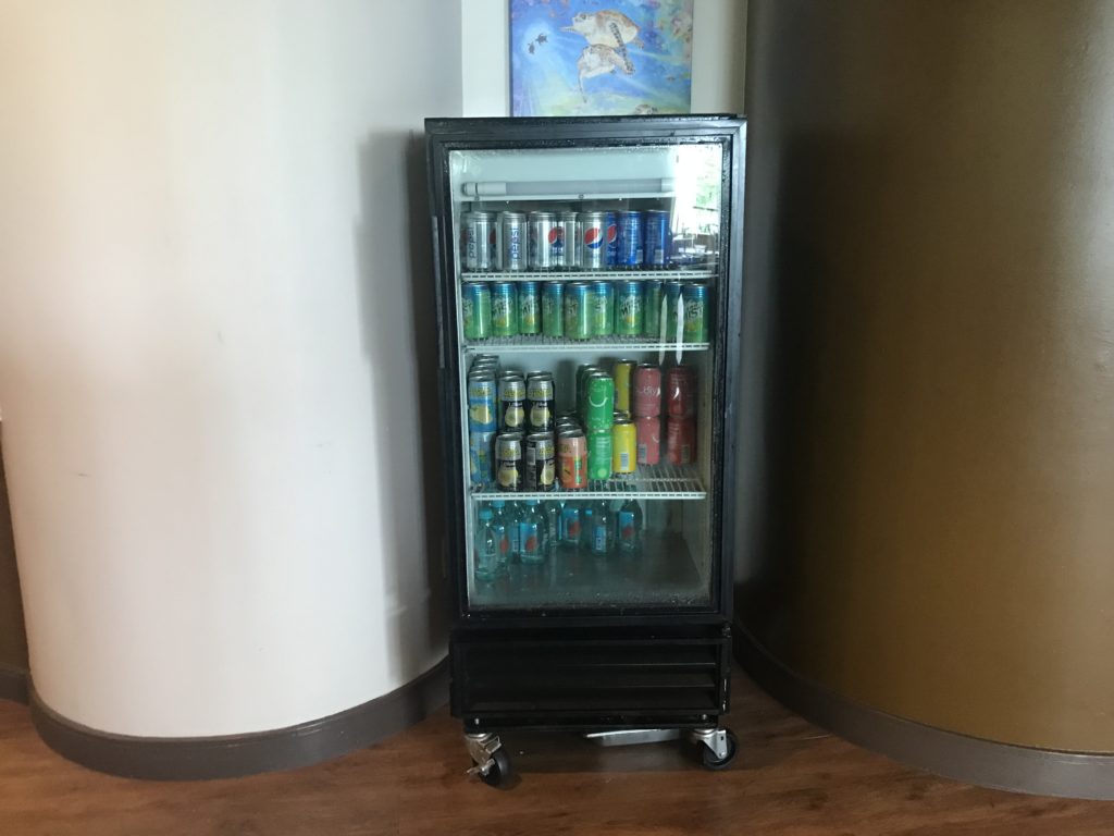 a refrigerator with cans of beverage in it