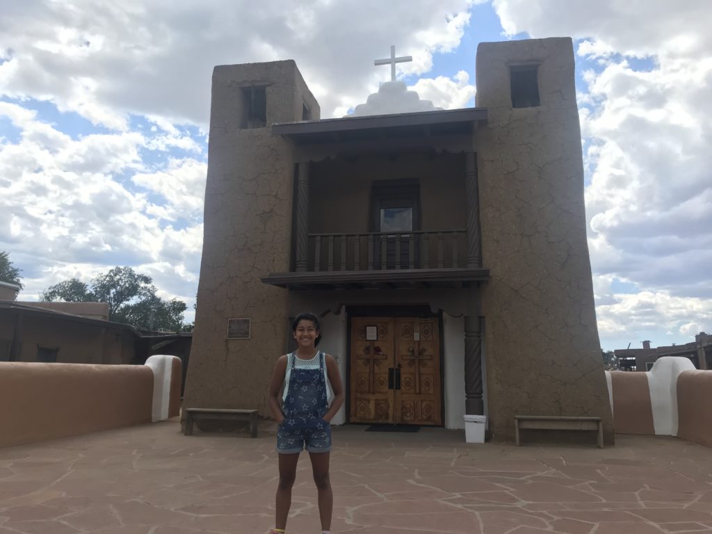 a girl standing in front of a building