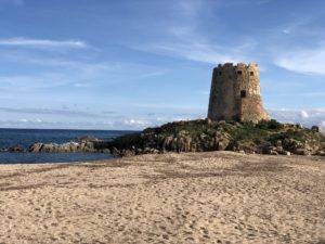 a tower on a rocky beach