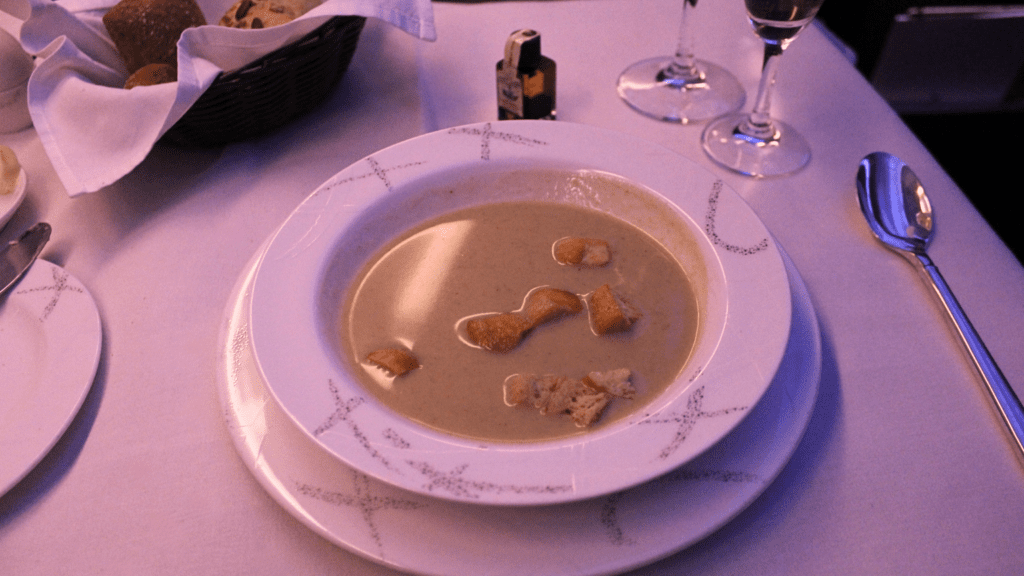 A bowl of broccoli cheddar soup served on Cathay Pacific