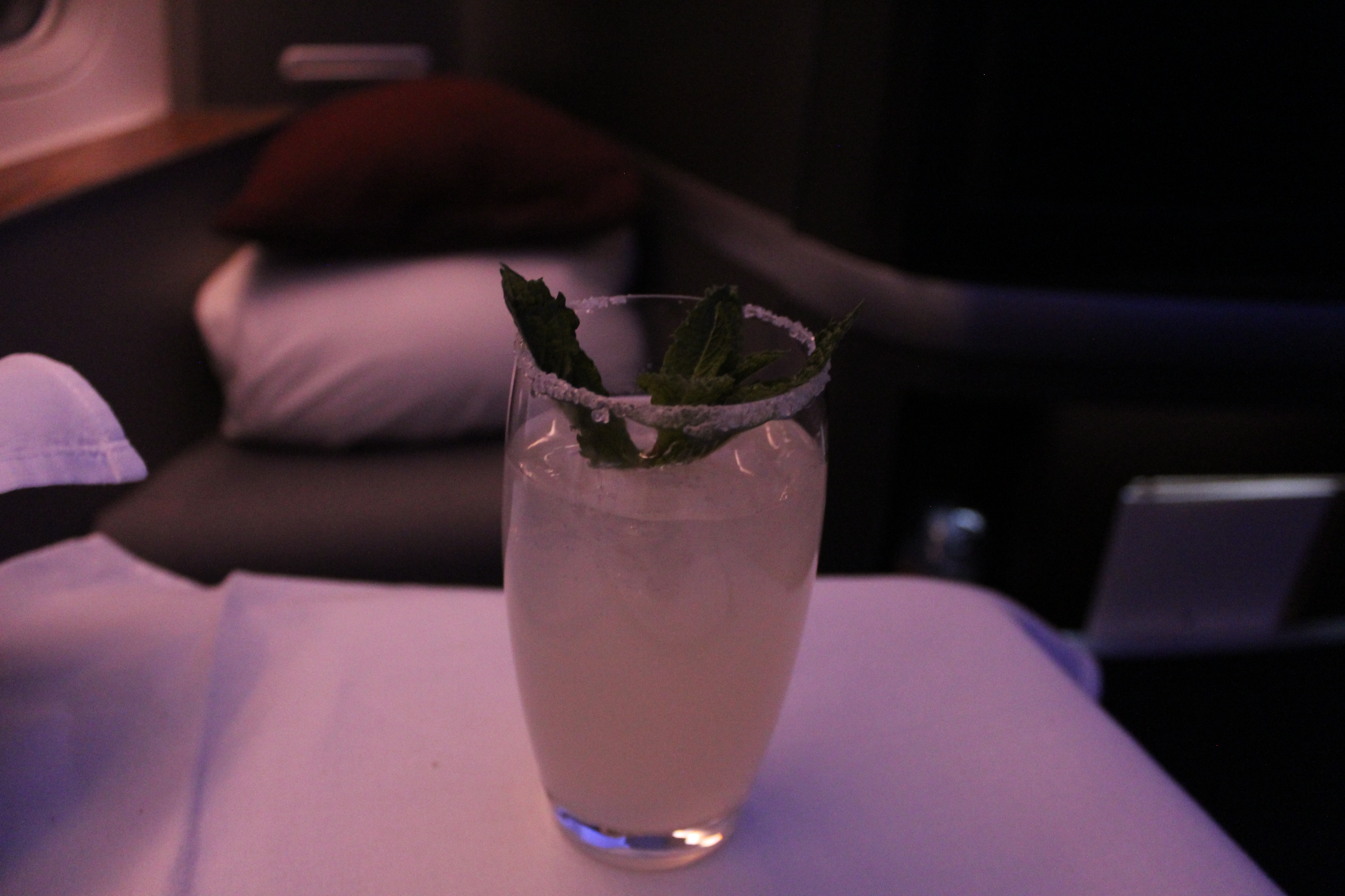 a glass with a drink and a leaf on top