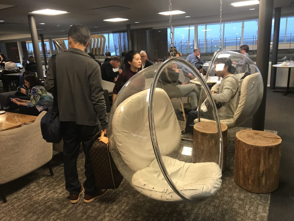 a group of people in a room with chairs