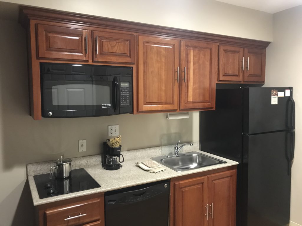 a kitchen with wooden cabinets and black appliances