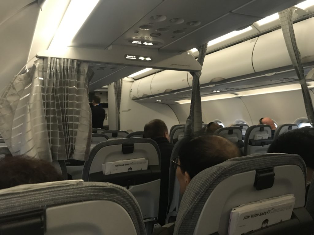 a group of people sitting in an airplane