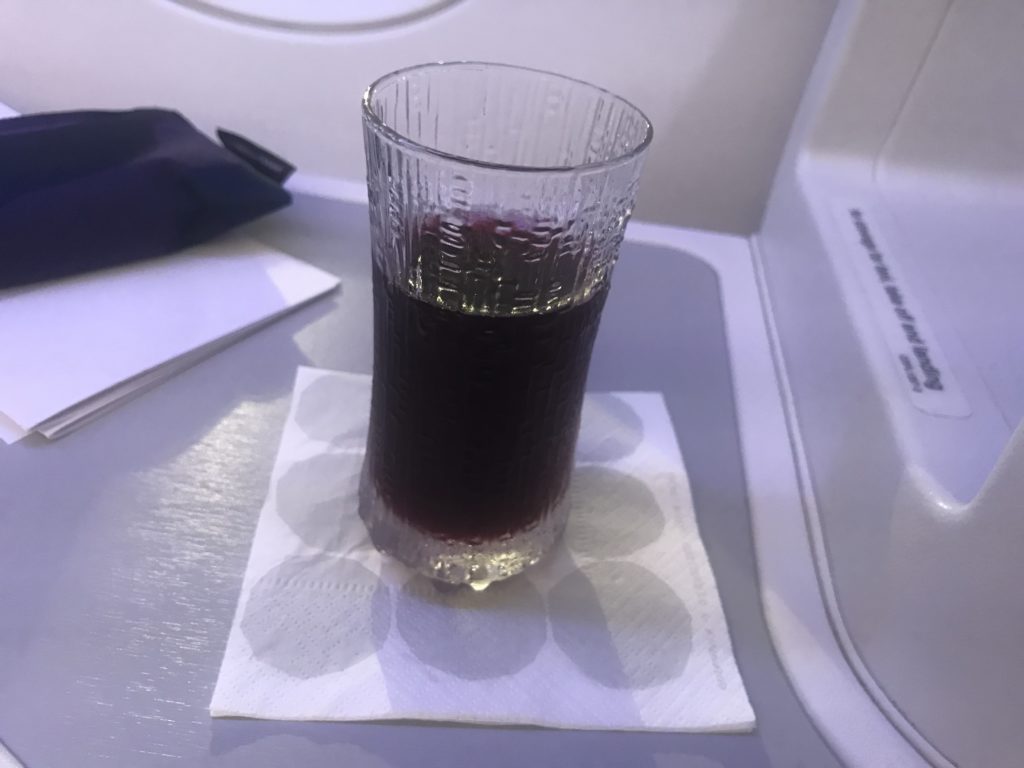 a glass of liquid on a napkin