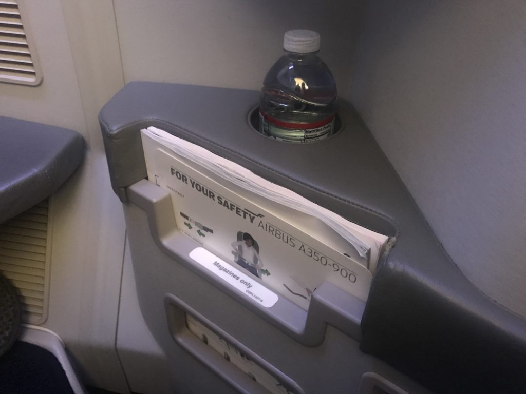 a bottle in a holder on a seat