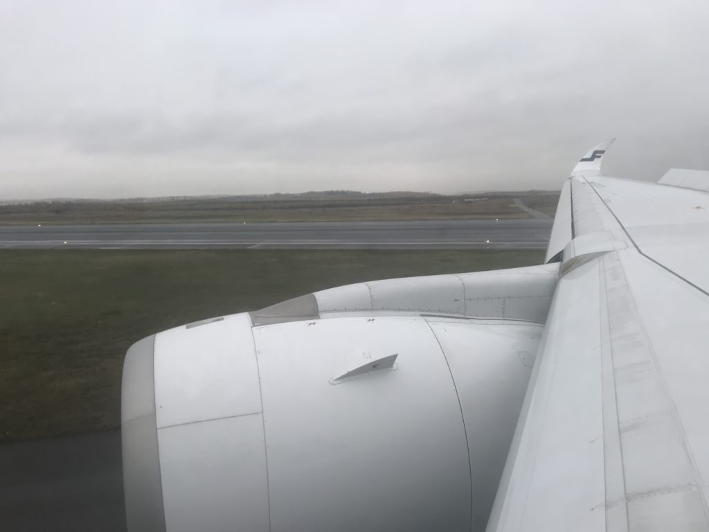 an airplane wing and engine on a runway