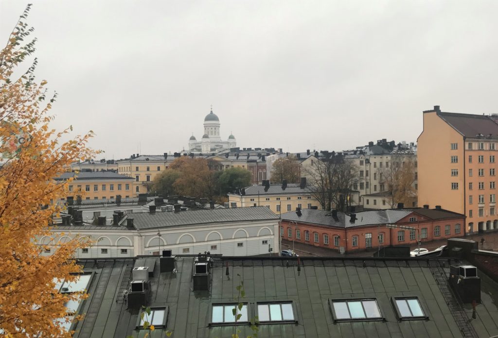 a group of buildings with a dome in the background