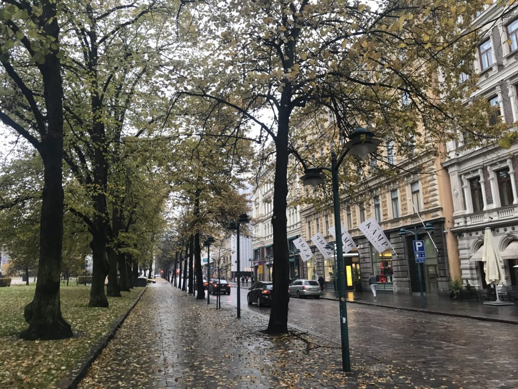a street with trees and flags on it