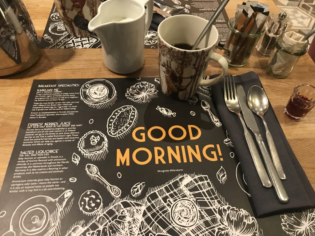 a table with a menu and a cup of coffee