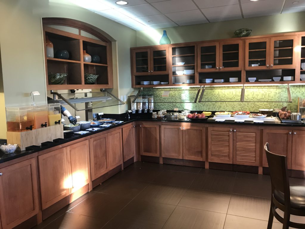 a kitchen with wood cabinets and food on the counter