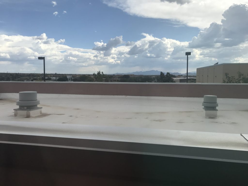 a roof top with a view of the city from the window