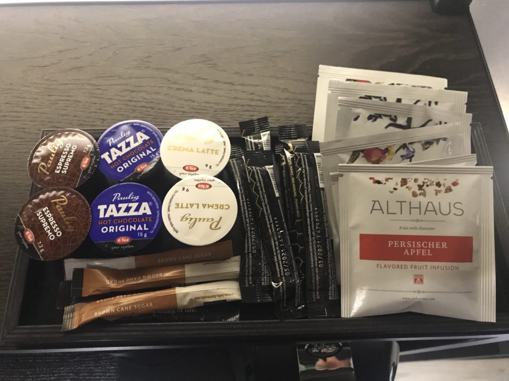 a tray of coffee condiments and packets