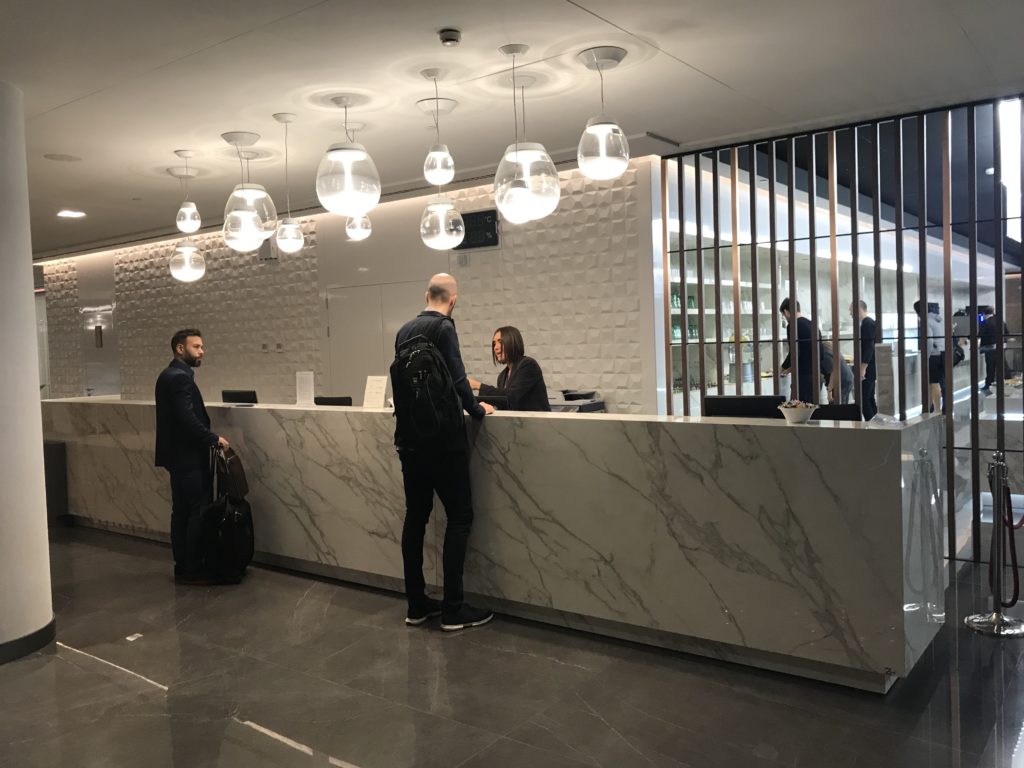 a group of people standing at a reception desk