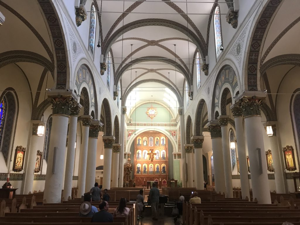 a church with many people sitting in the pews