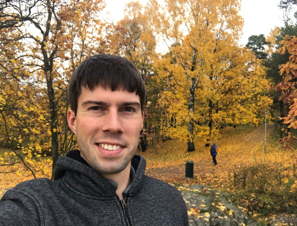 a man taking a selfie in a park