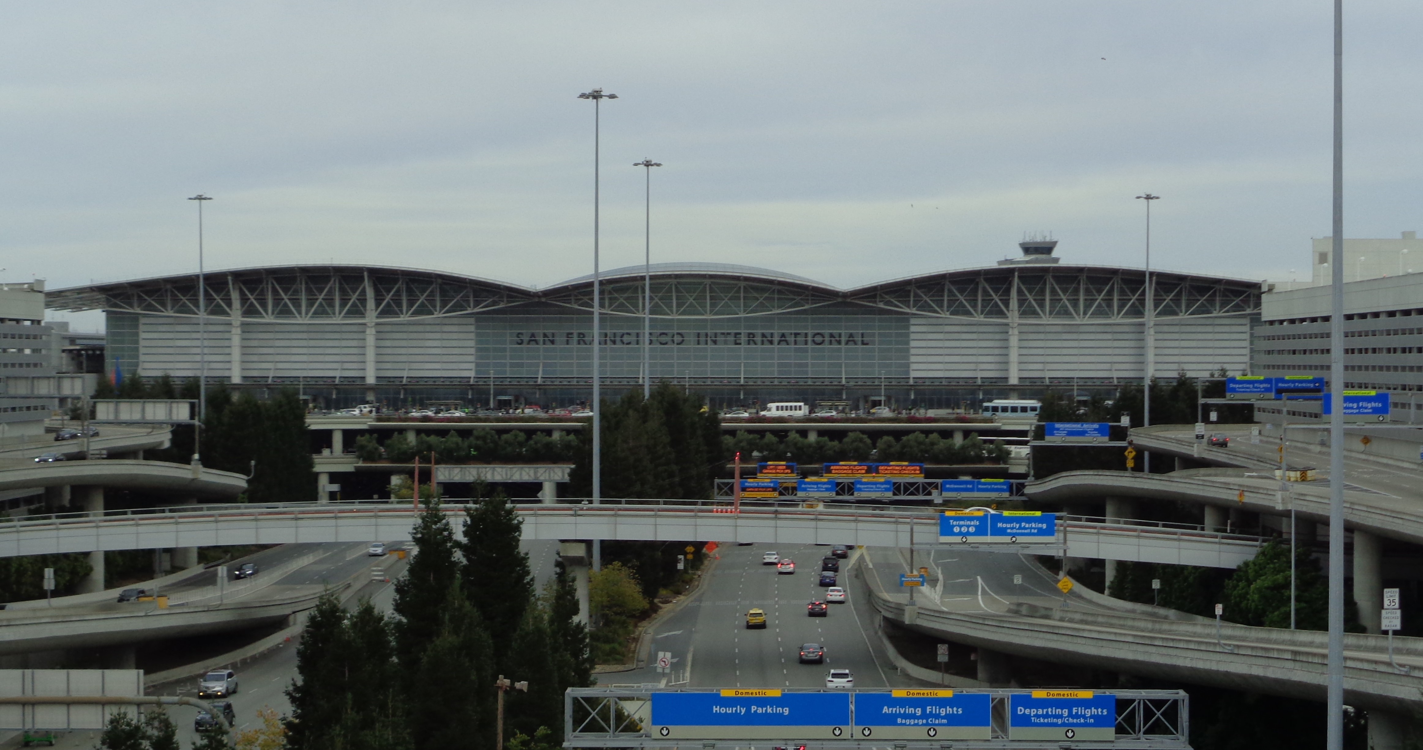 a large airport with a large building and a lot of cars