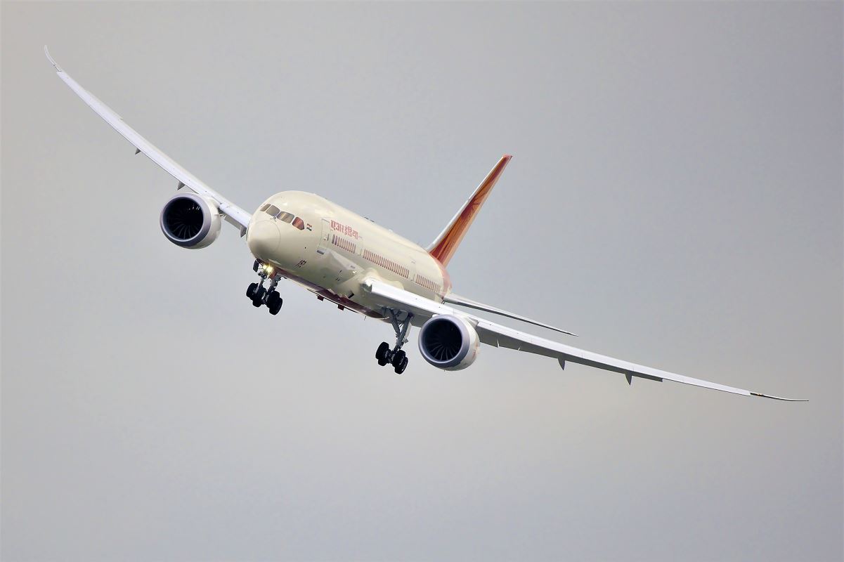 a white airplane flying in the sky