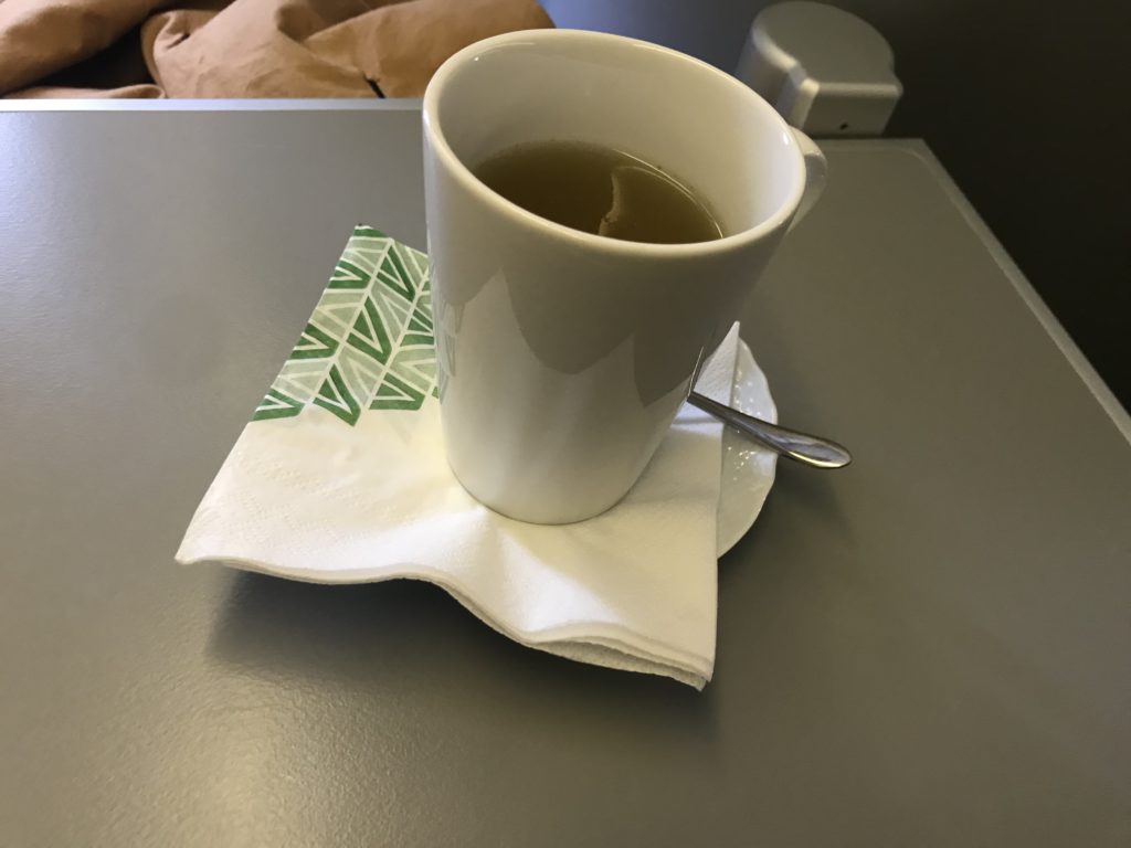 a cup of liquid on a napkin