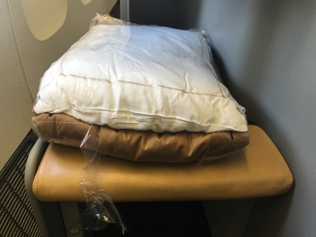 a stack of pillows on a seat