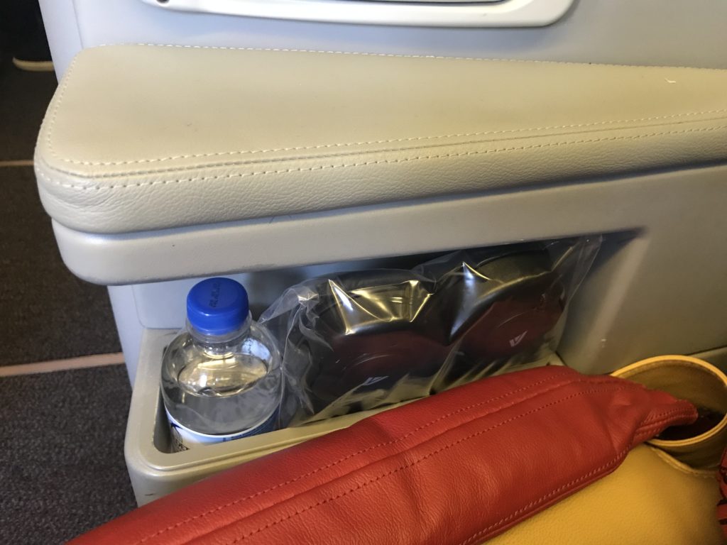 a plastic bottle in a plastic bag in a seat