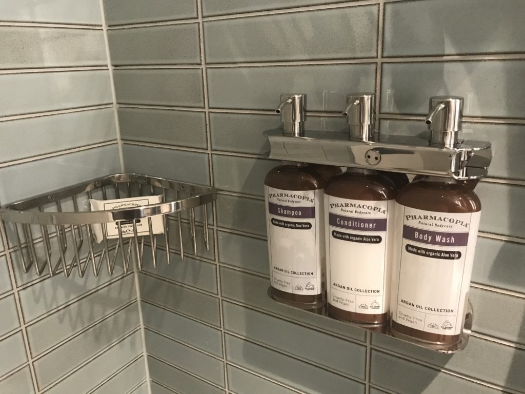 a group of bottles of shampoo and conditioner on a shelf