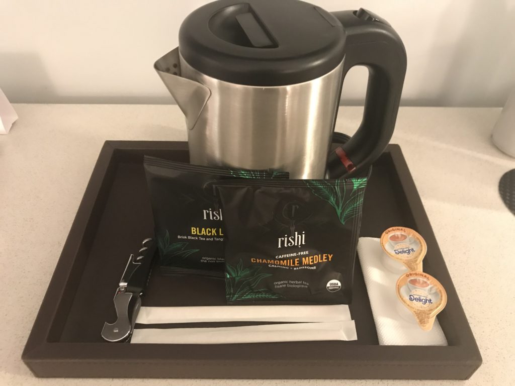 a tray with a teapot and tea bags