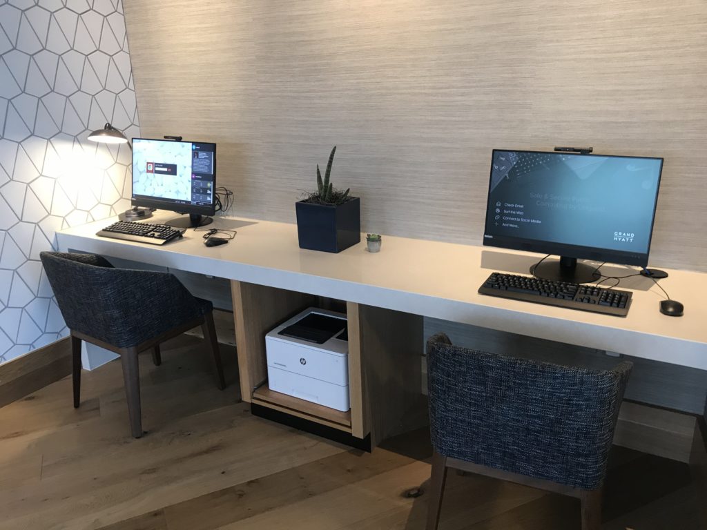a desk with two computers on it