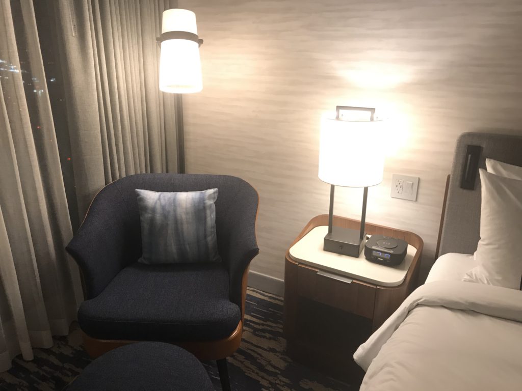 a room with a chair and a lamp