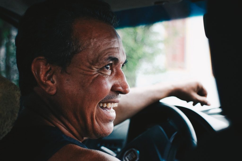 a man smiling in a car