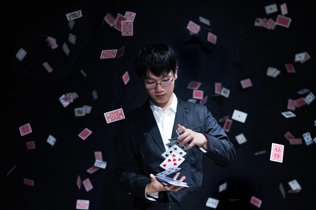 a man in a suit playing cards