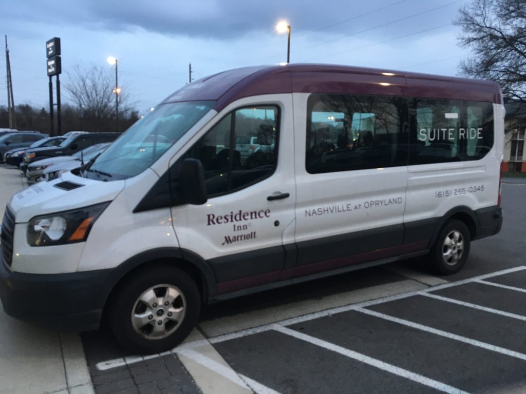 a white and purple van in a parking lot