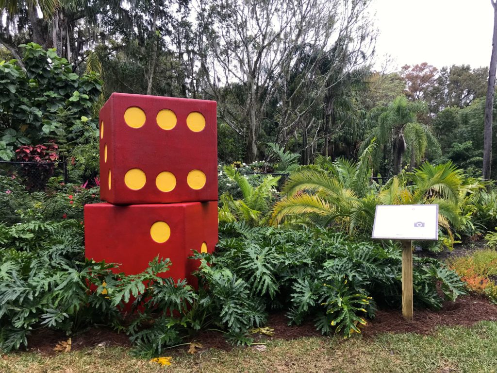 a large red and yellow dice in a garden