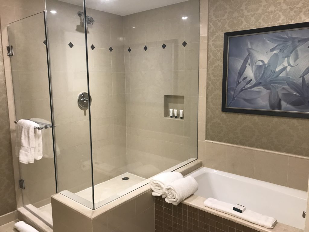 a bathroom with a glass shower and bathtub