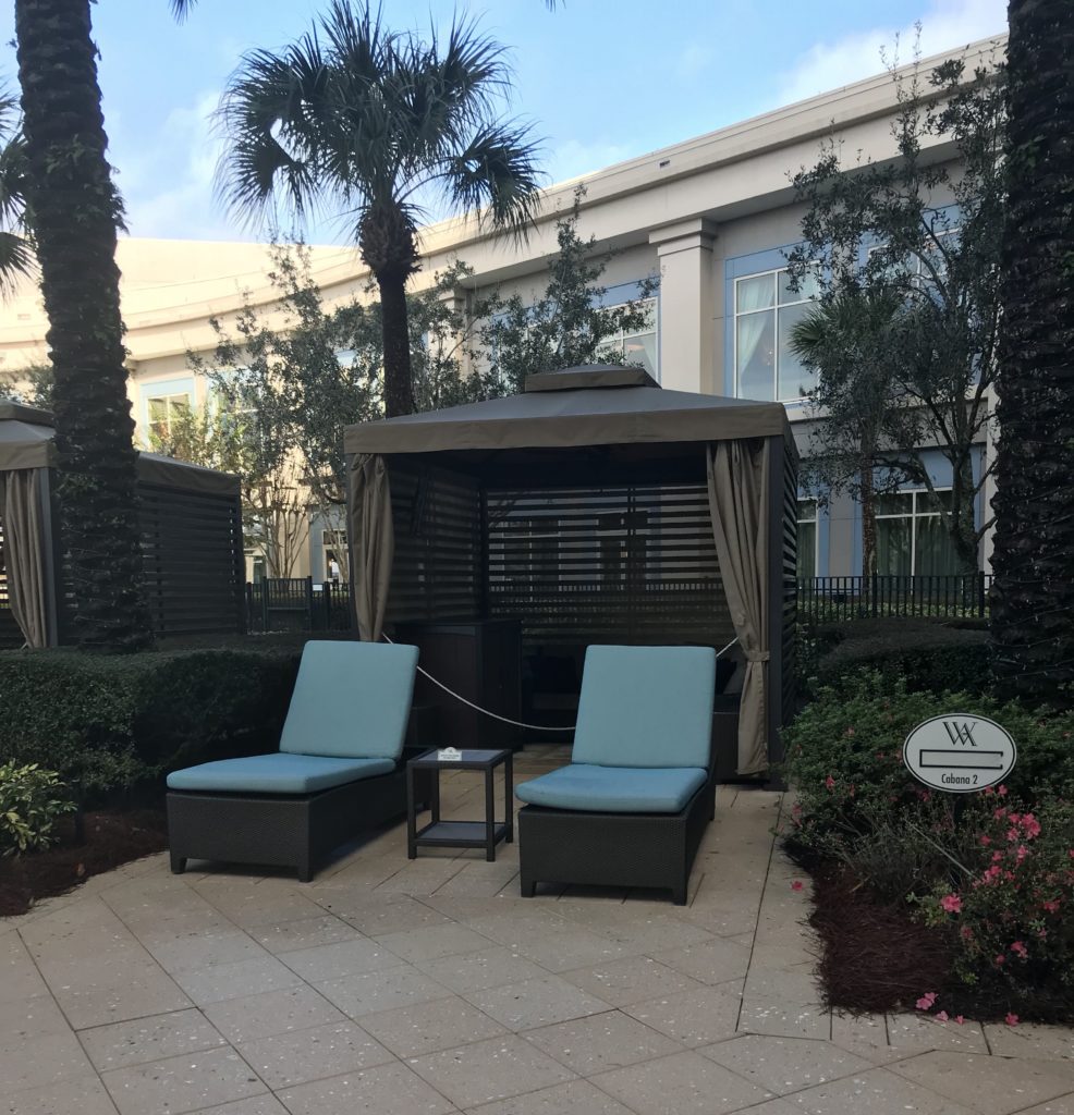 a lounge chairs and a table outside of a building