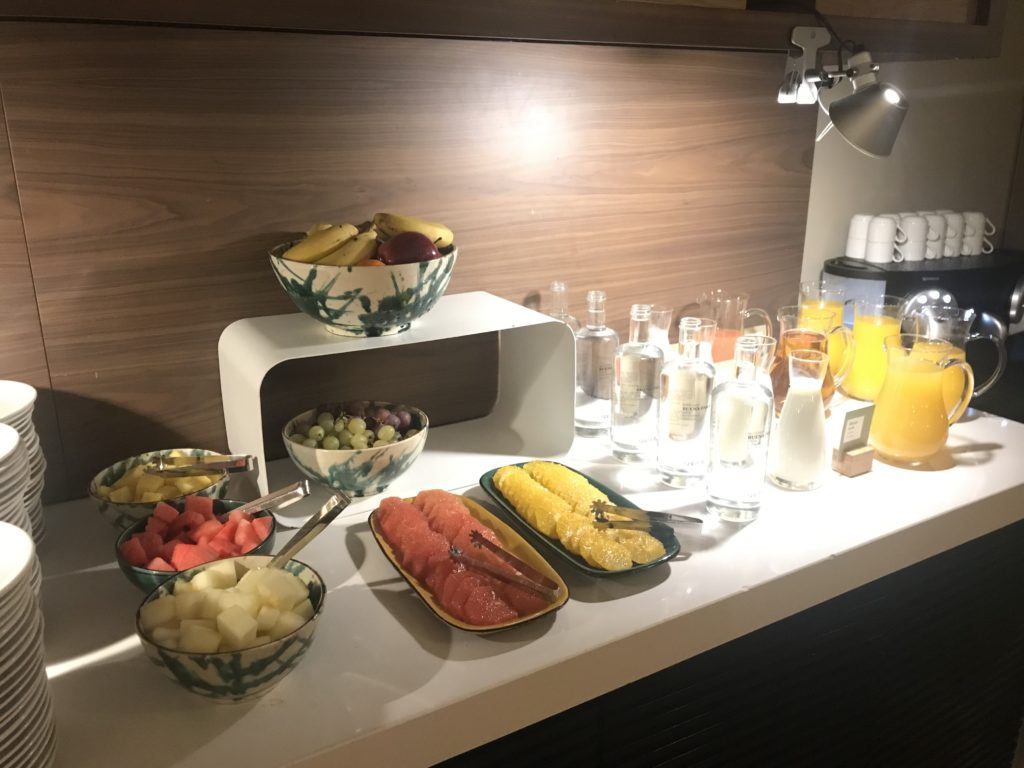 a table with fruit and drinks on it