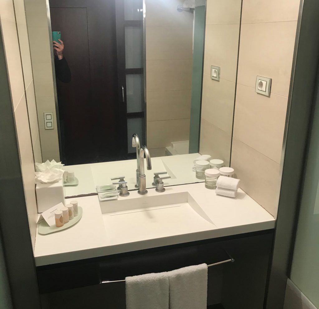 a mirror with a sink and a towel on it