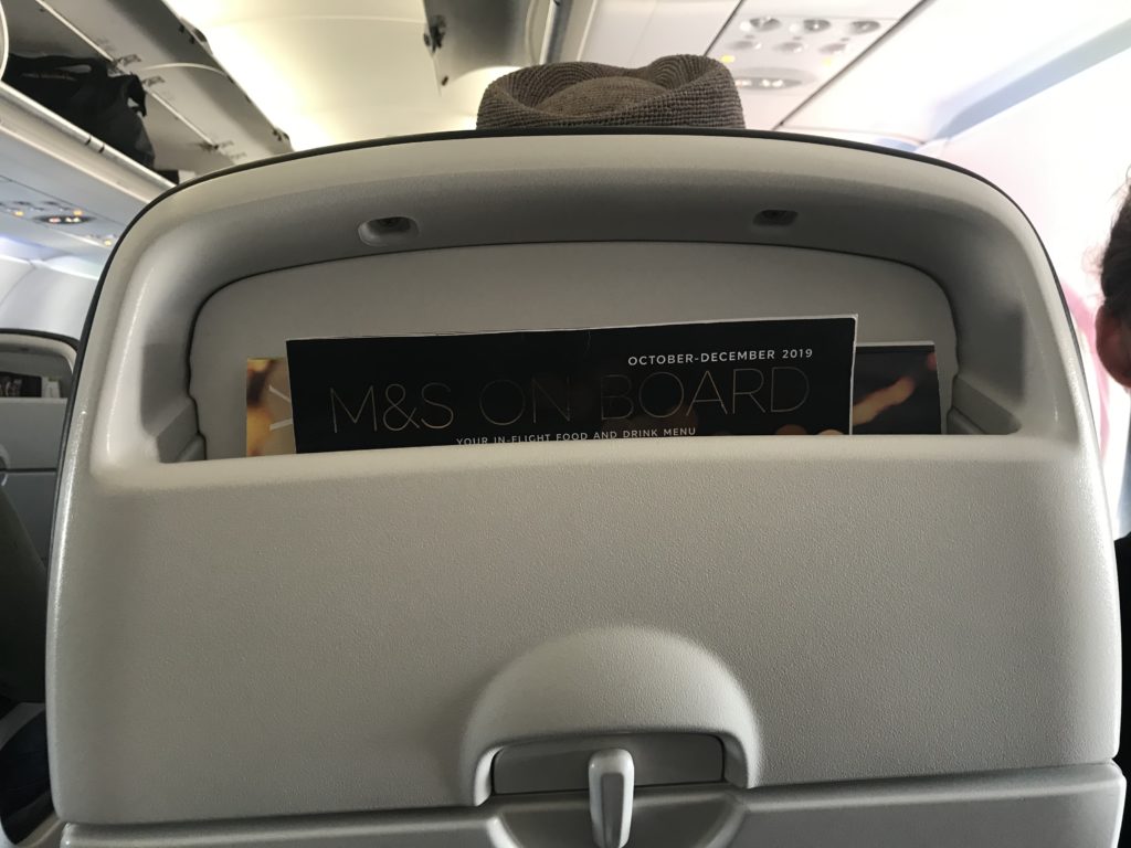 a magazine in the back of a seat