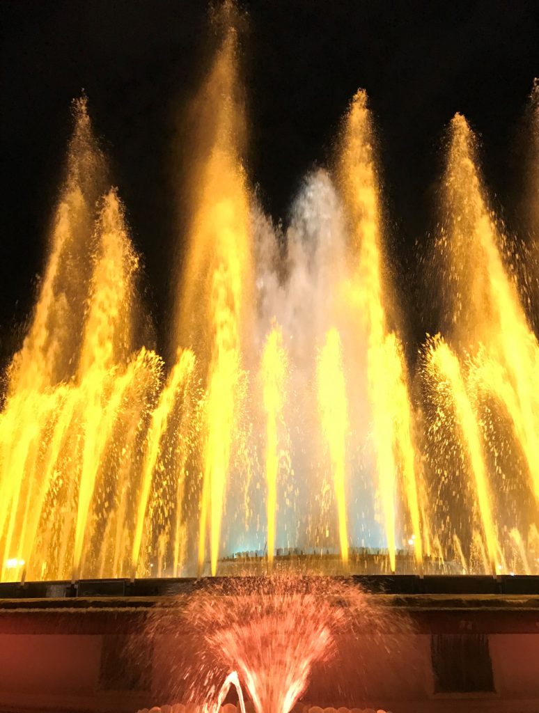 a water fountain with yellow lights