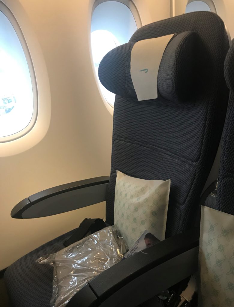a seat with a pillow and a pillow in it