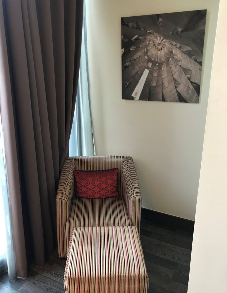 a chair and a painting on the wall