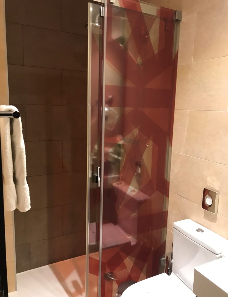 a glass shower door in a bathroom