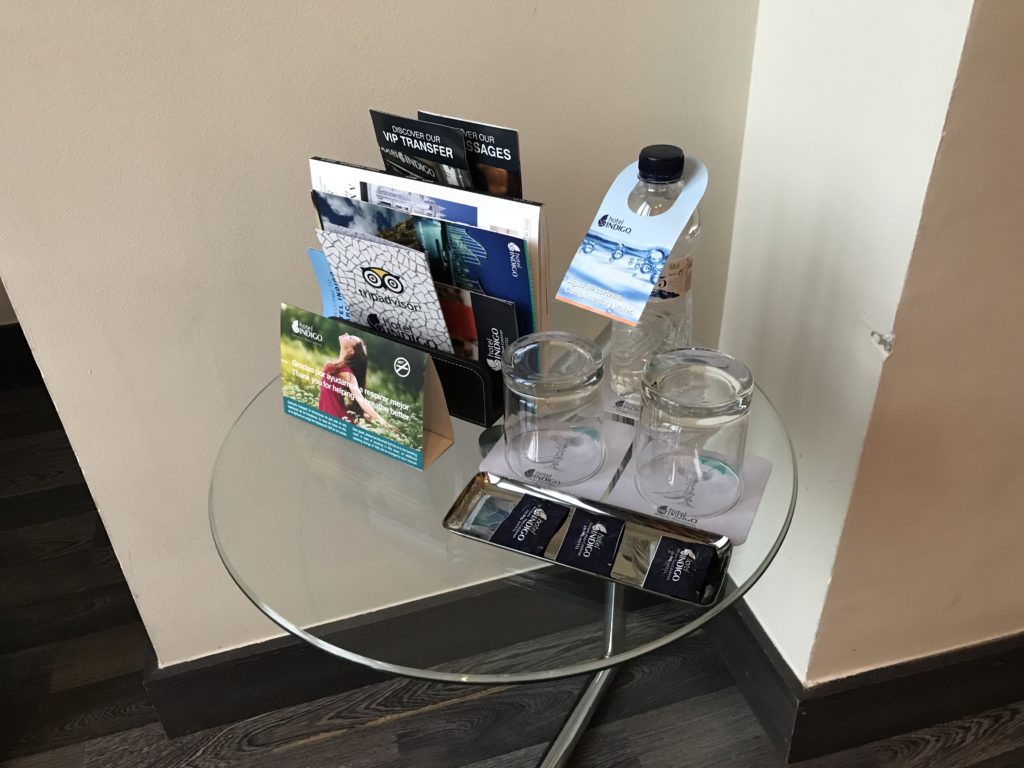 a glass table with a few glasses and a bottle of water