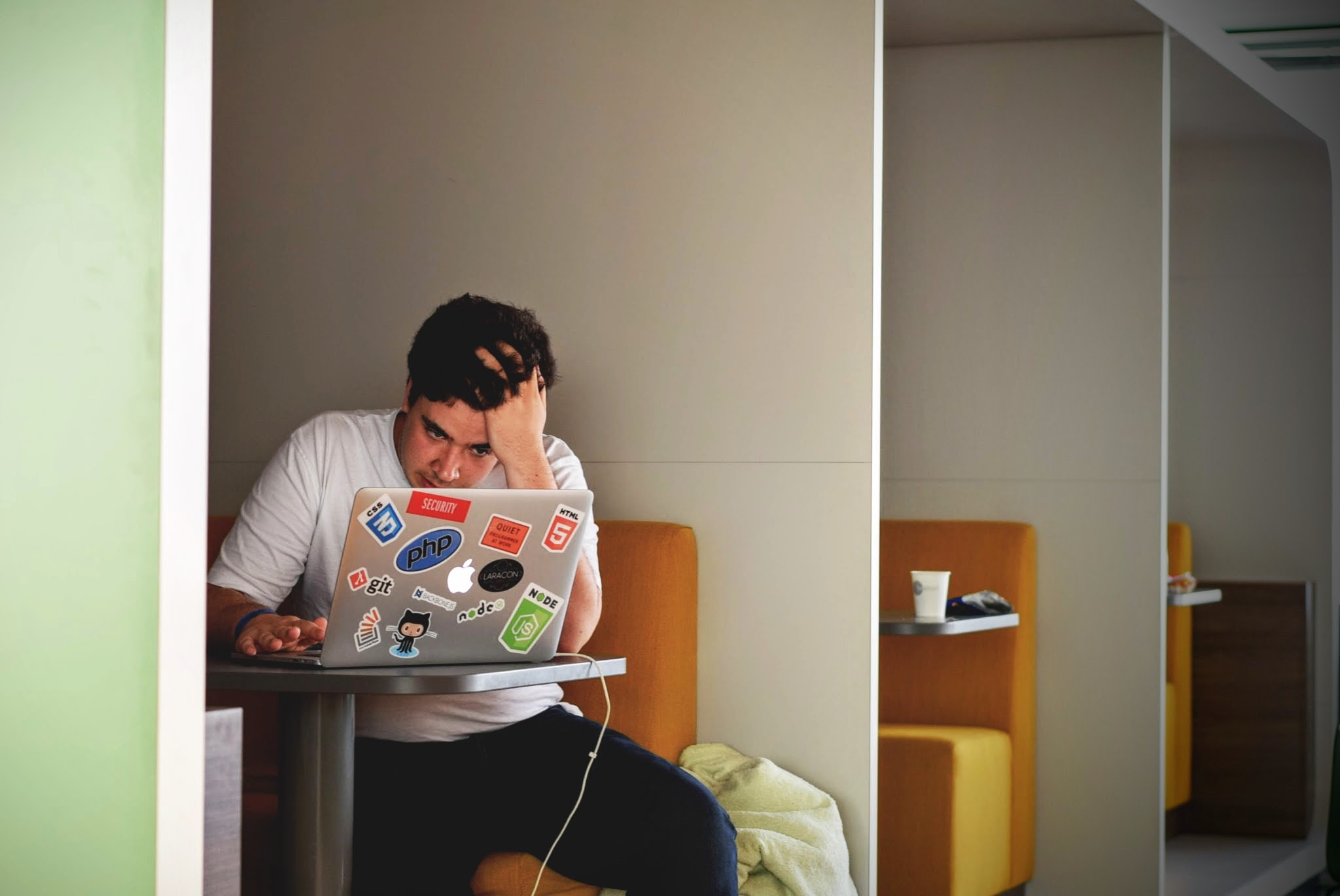 a man sitting at a table with a laptop