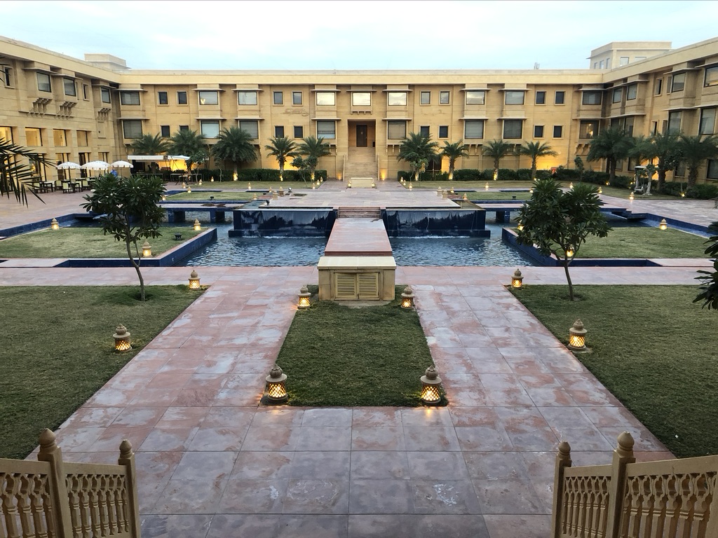 a courtyard with a pool and trees